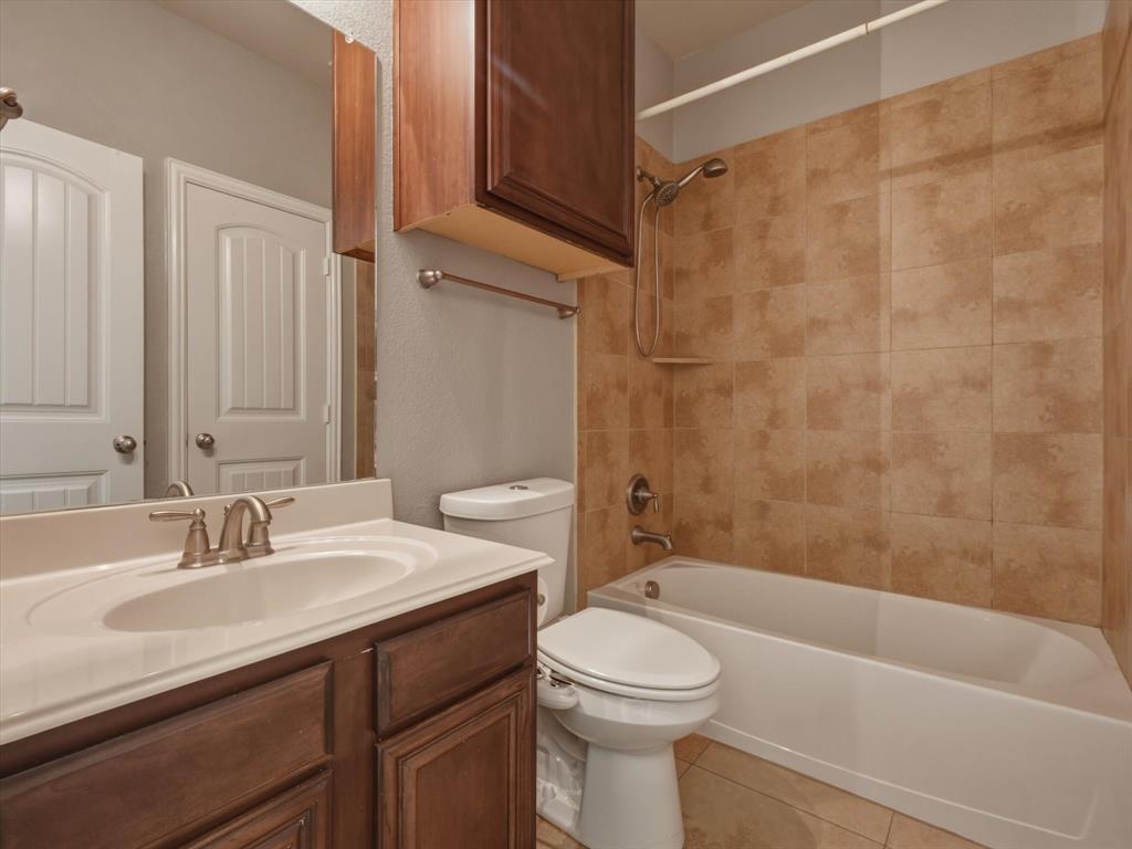 2364 Ranchview Drive Little Elm, TX 75068 - Photo 18 of 33 Vanity with integrated sink, wood-finish cabinetry, and brushed nickel fixtures