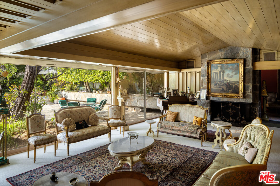 1018 North Crescent Drive Beverly Hills, CA 90210 - Photo 11 of 18 a living room with furniture and a large window