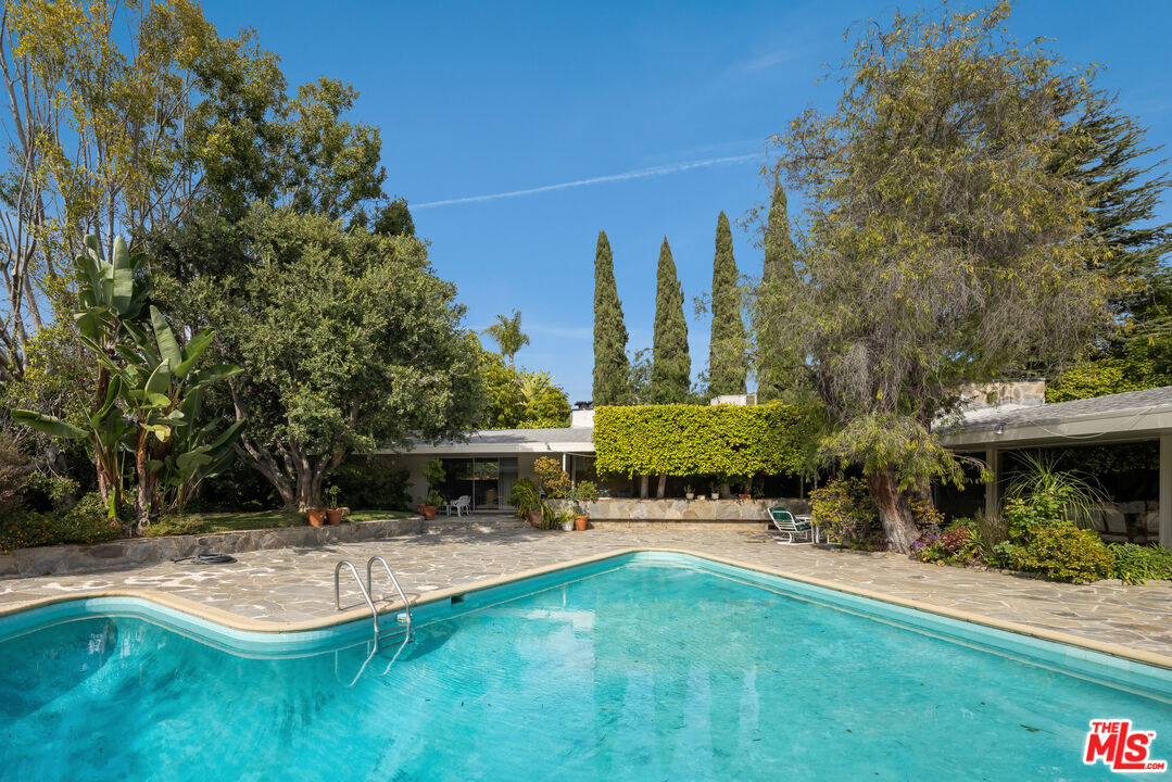 1018 North Crescent Drive Beverly Hills, CA 90210 - Photo 14 of 18 a swimming pool with outdoor seating and yard