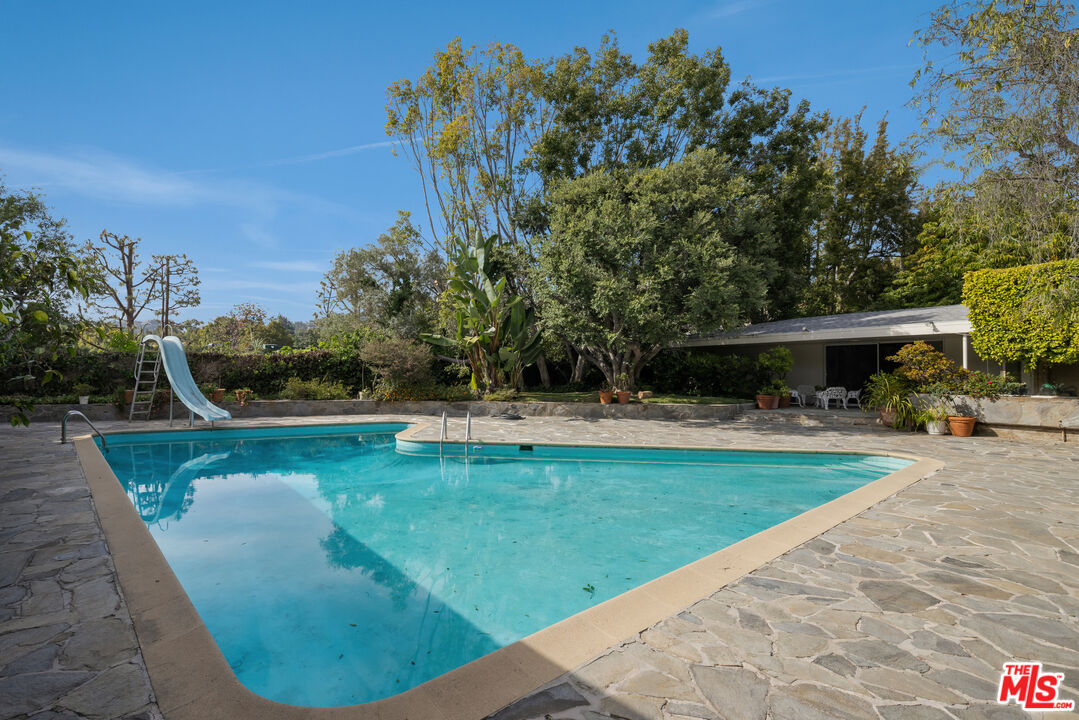 1018 North Crescent Drive Beverly Hills, CA 90210 - Photo 5 of 18 a view of a swimming pool with a patio