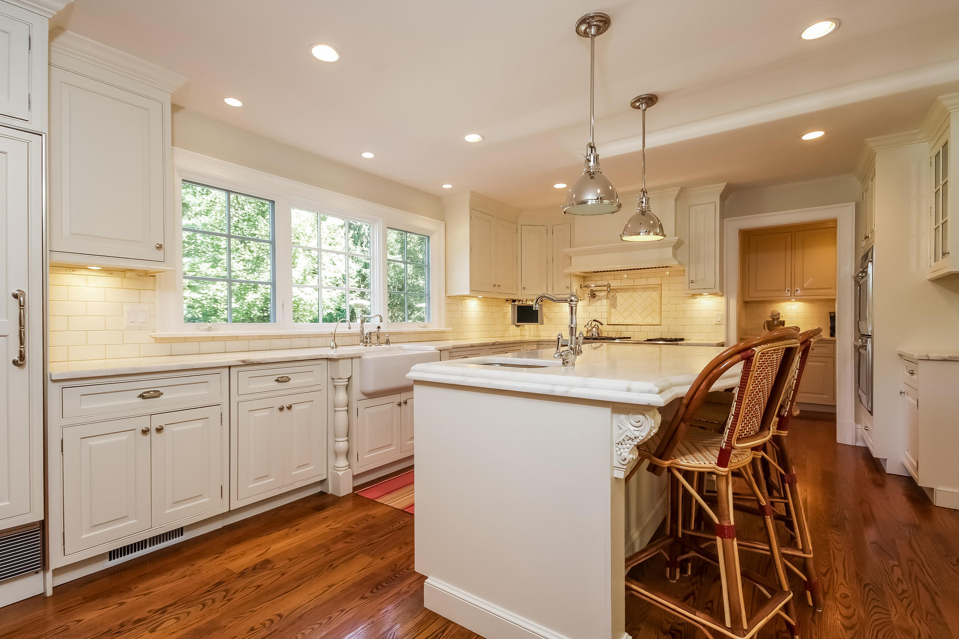 170 Brushy Ridge Road New Canaan, CT 06840 - Photo 18 of 56 a kitchen with stainless steel appliances kitchen island granite countertop a stove a sink and white cabinets with wooden floor