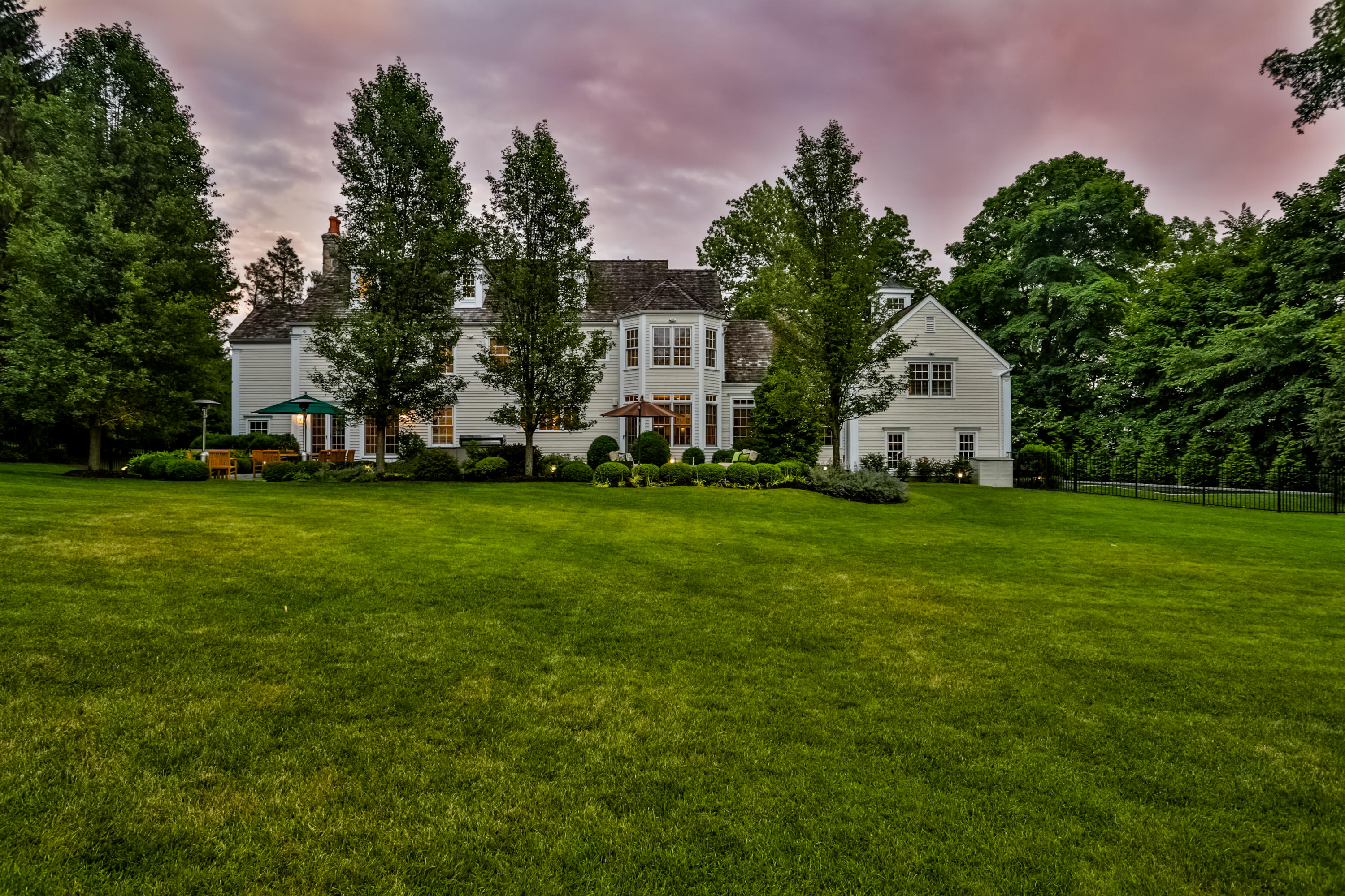 170 Brushy Ridge Road New Canaan, CT 06840 - Photo 4 of 56 a front view of a house with a yard