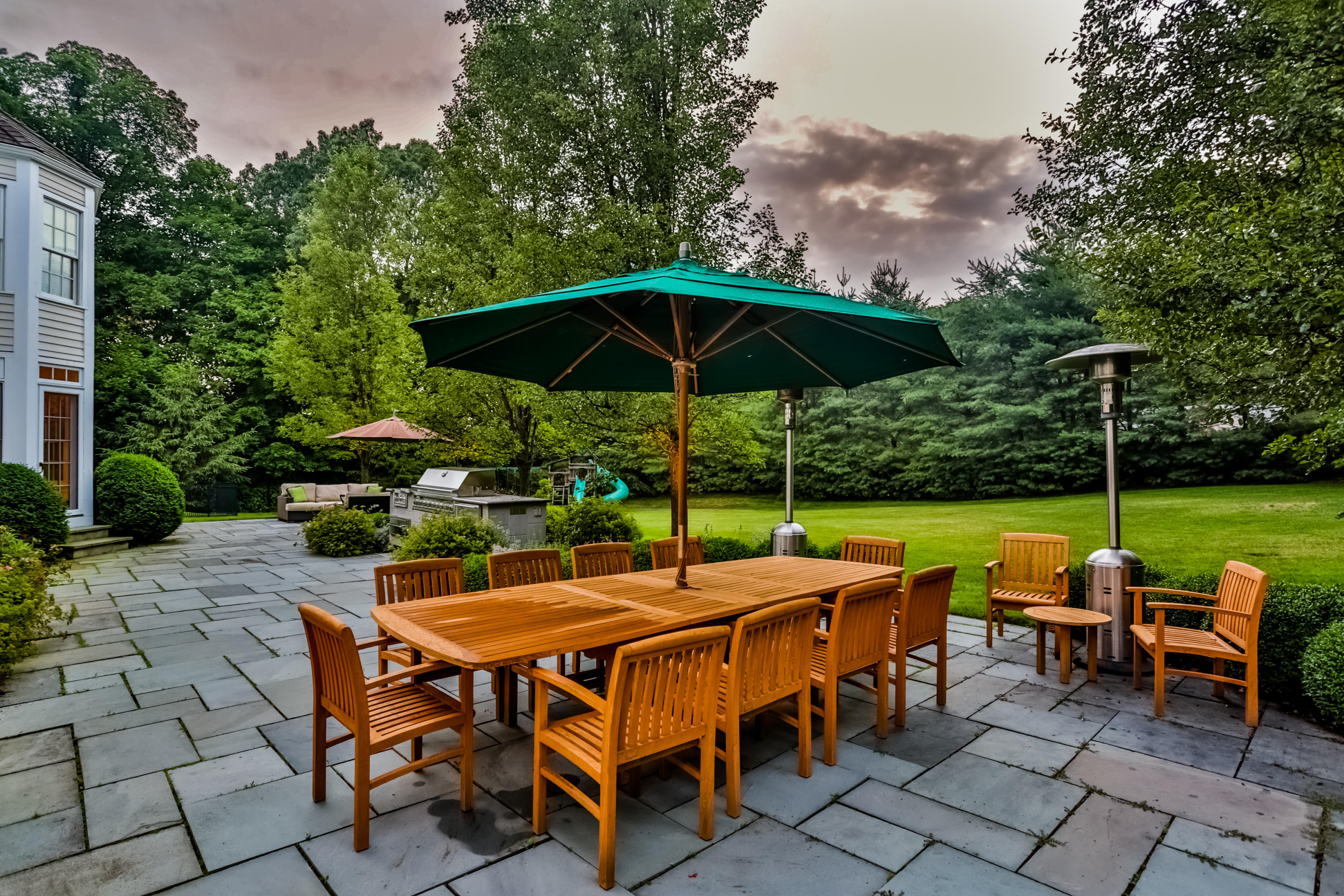 170 Brushy Ridge Road New Canaan, CT 06840 - Photo 47 of 56 a view of an outdoor sitting area with chairs and umbrella