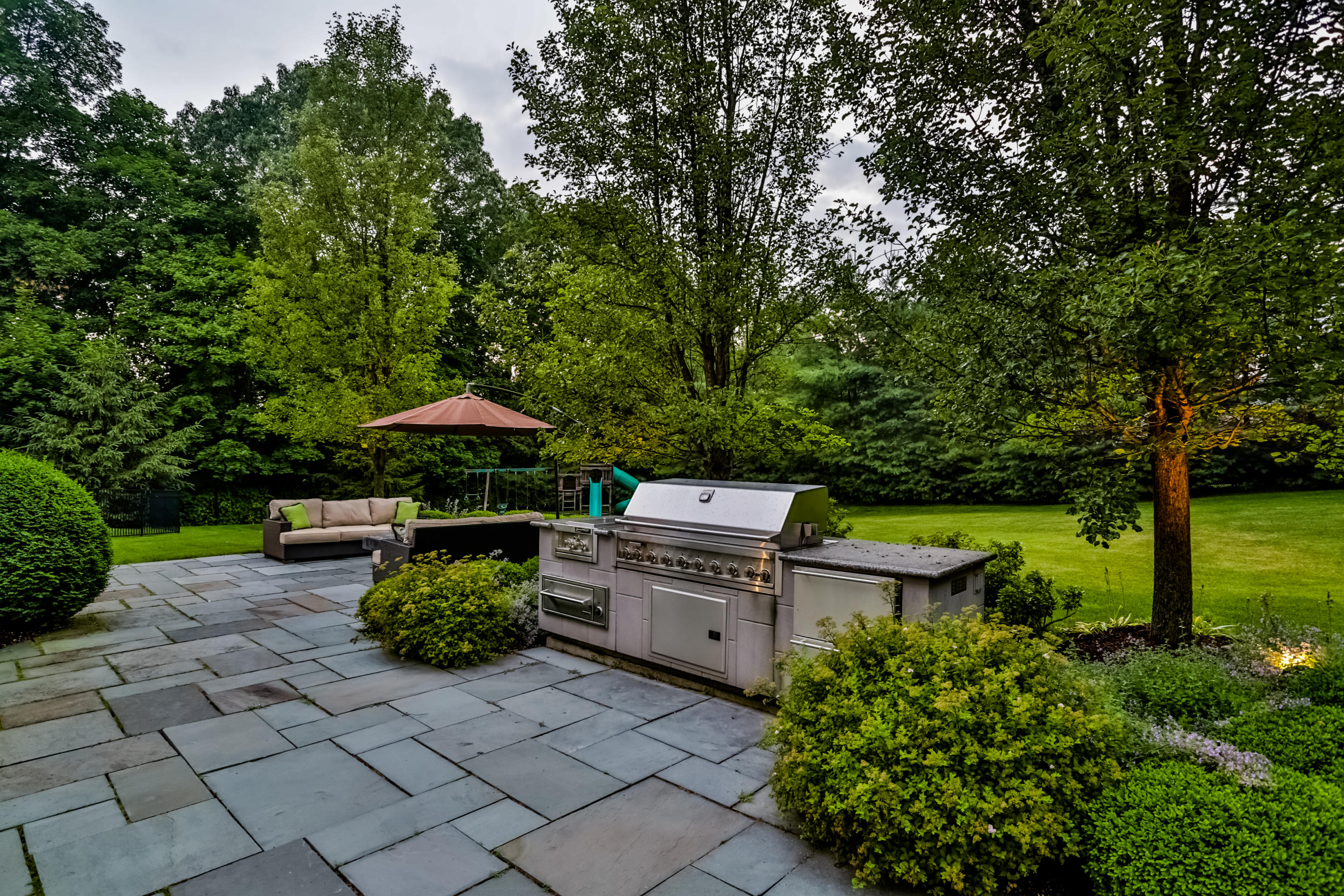 170 Brushy Ridge Road New Canaan, CT 06840 - Photo 48 of 56 a backyard of a house with yard and outdoor seating