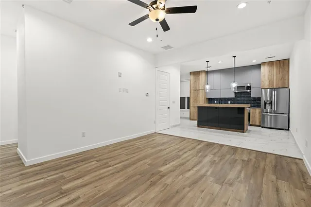 a kitchen with granite countertop a refrigerator and a sink