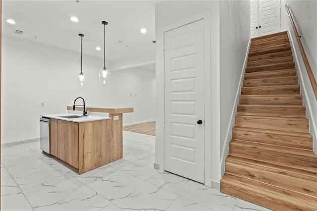 a view of a livingroom with wooden floor and a flat screen tv