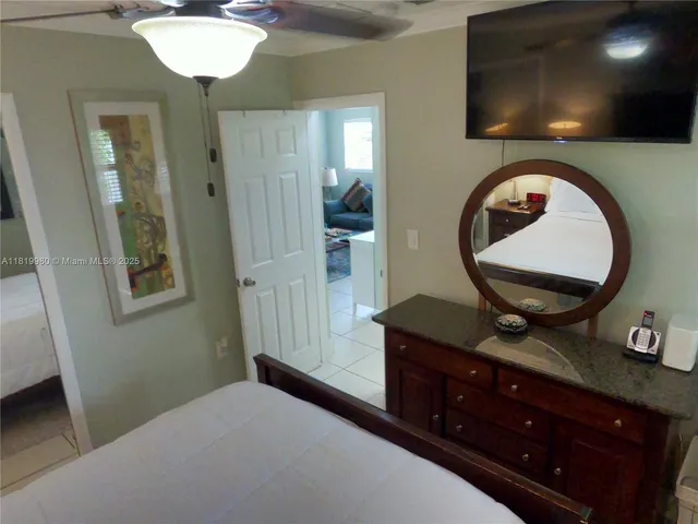 a bedroom with a sink and a mirror