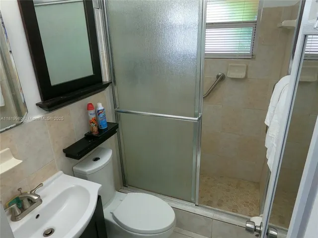 a bathroom with a toilet sink and shower