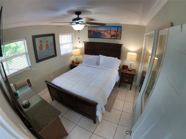 a bedroom with a bed dresser and a window