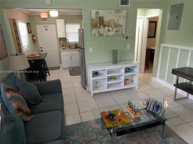 a living room with furniture and a painting on the wall