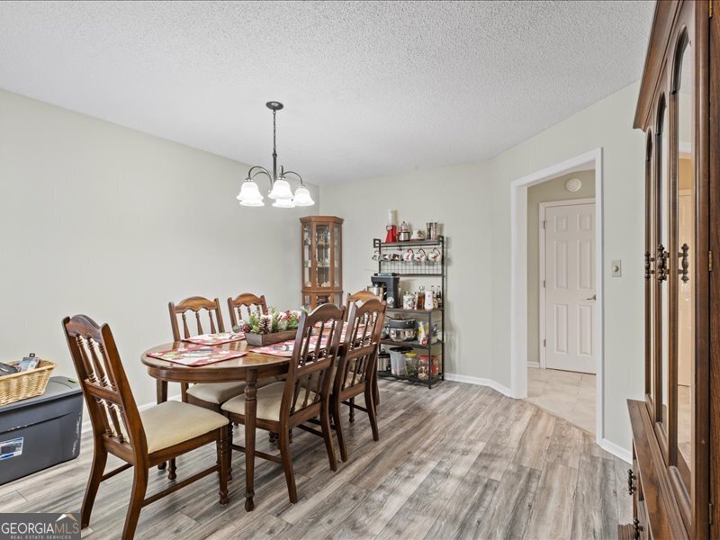1508 Liberty Expressway Albany, GA 31705 - Photo 19 of 55 a dining room with furniture and chandelier
