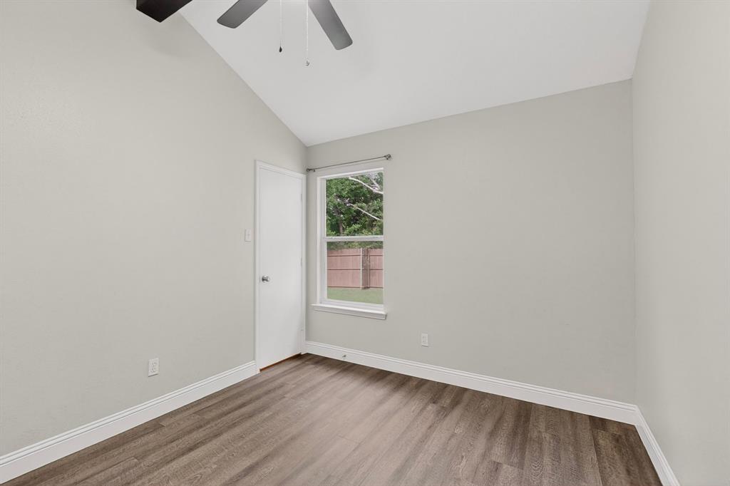 7729 Misty Ridge Drive North Fort Worth, TX 76137 - Photo 21 of 30 a view of an empty room with wooden floor and a window