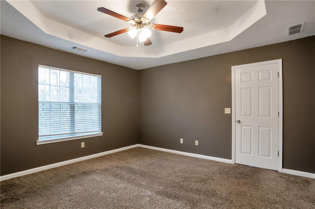 4598 Jackam Ridge Court Lithonia, GA 30038 - Photo 12 of 25 an empty room with windows and fan