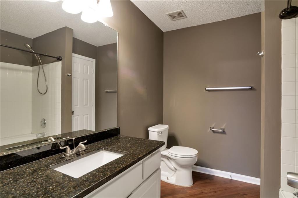 4598 Jackam Ridge Court Lithonia, GA 30038 - Photo 14 of 25 a bathroom with a granite countertop sink toilet and shower