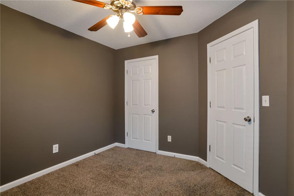 4598 Jackam Ridge Court Lithonia, GA 30038 - Photo 18 of 25 an empty room and chandelier fan