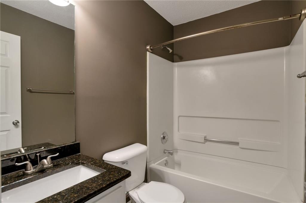 4598 Jackam Ridge Court Lithonia, GA 30038 - Photo 19 of 25 a bathroom with a sink toilet and shower