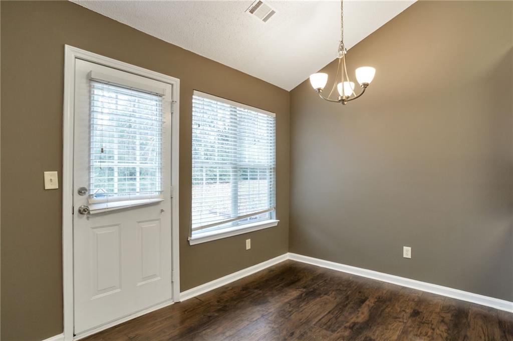4598 Jackam Ridge Court Lithonia, GA 30038 - Photo 9 of 25 a view of an empty room with wooden floor and a window