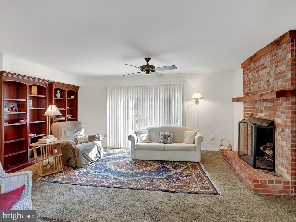 9115 Rockefeller Lane Springfield, VA 22153 - Photo 16 of 29 a living room with furniture and a fireplace