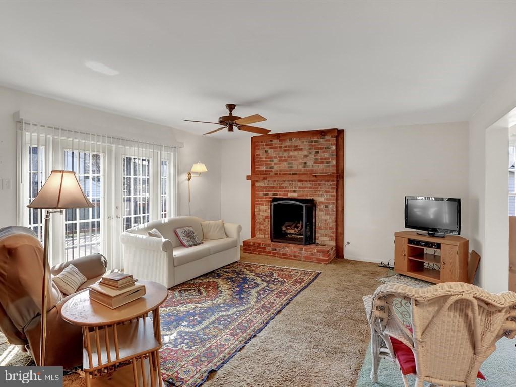 9115 Rockefeller Lane Springfield, VA 22153 - Photo 17 of 29 a living room with furniture and a fireplace