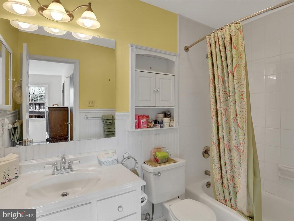 9115 Rockefeller Lane Springfield, VA 22153 - Photo 22 of 29 a bathroom with a sink vanity mirror and toilet