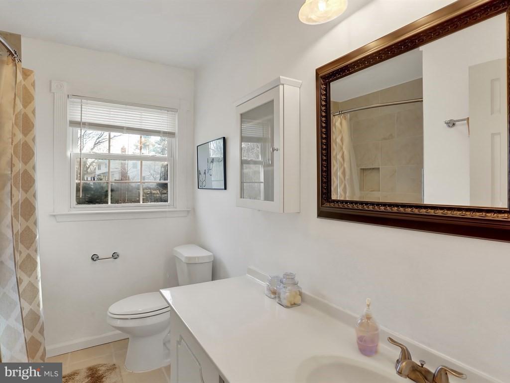 9115 Rockefeller Lane Springfield, VA 22153 - Photo 23 of 29 a bathroom with a toilet sink and mirror