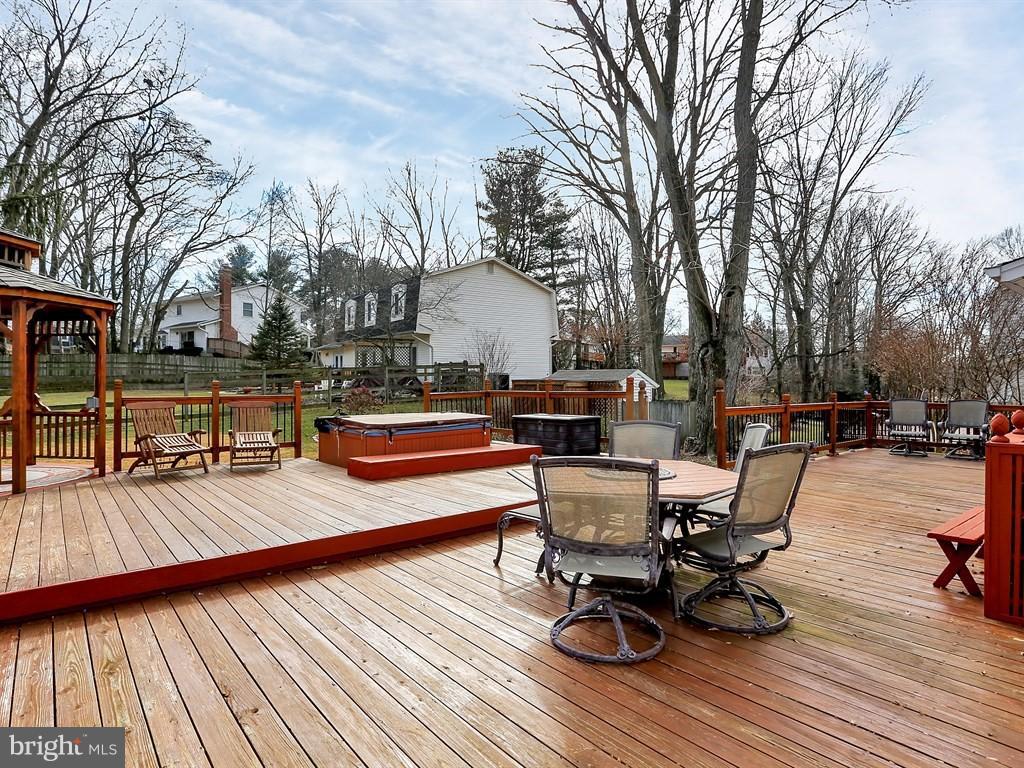 9115 Rockefeller Lane Springfield, VA 22153 - Photo 27 of 29 a view of a roof deck with table and chairs and wooden floor