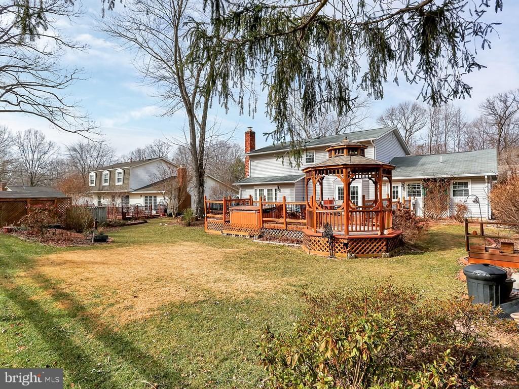 9115 Rockefeller Lane Springfield, VA 22153 - Photo 28 of 29 a view of a big yard with table and chairs under an umbrella