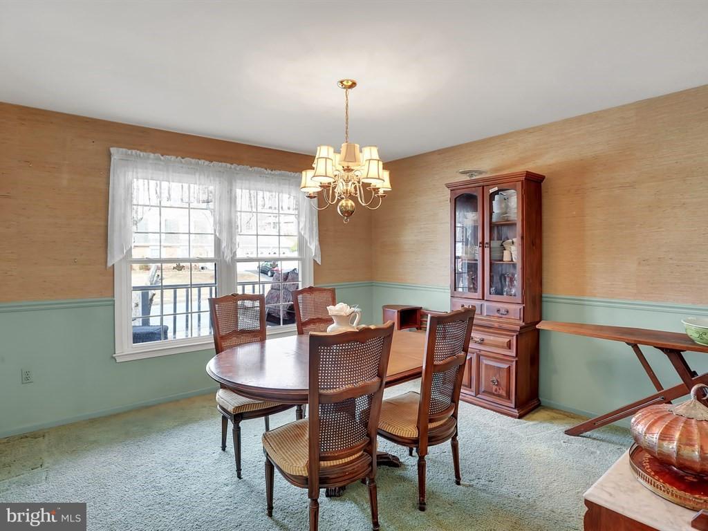 9115 Rockefeller Lane Springfield, VA 22153 - Photo 7 of 29 a dining room with furniture a chandelier and window