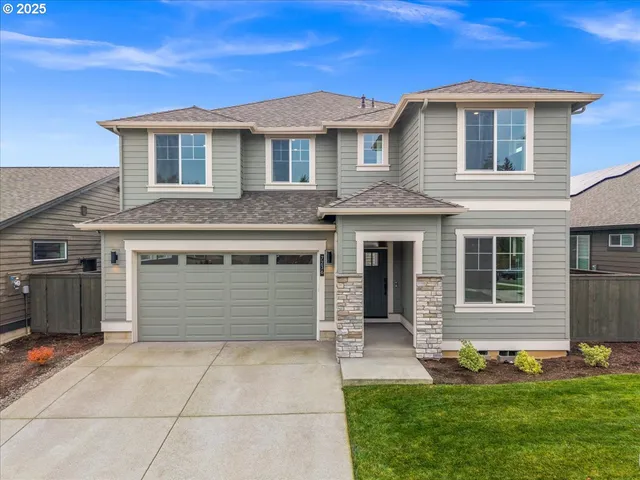 a front view of a house with a yard and garage