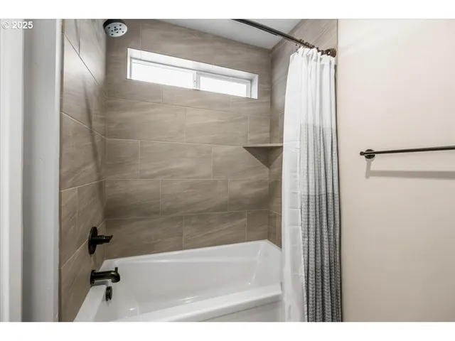 a bathroom with a bathtub and a shower