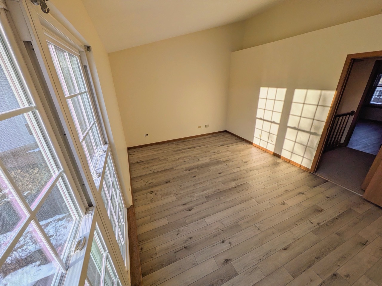 28 North Oltendorf Road, Unit 28 Streamwood, IL 60107 - Photo 11 of 13 a view of an empty room with wooden floor and a window
