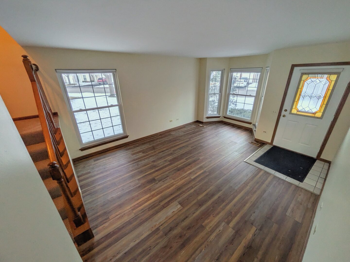 28 North Oltendorf Road, Unit 28 Streamwood, IL 60107 - Photo 3 of 13 a view of an empty room with wooden floor and windows