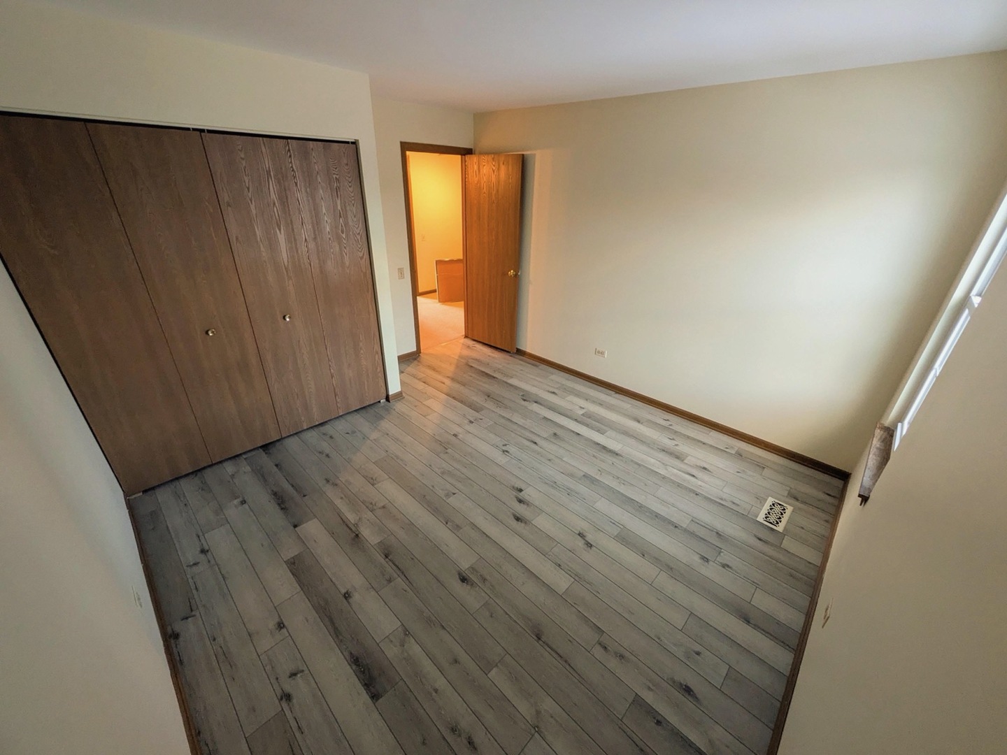 28 North Oltendorf Road, Unit 28 Streamwood, IL 60107 - Photo 8 of 13 a view of an empty room with wooden floor and a window