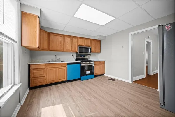 a kitchen with a refrigerator and a stove top oven