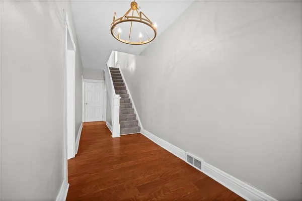 a view of a room with wooden floor and white walls