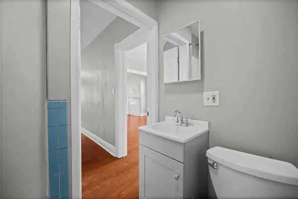 a bathroom with a sink toilet and a mirror