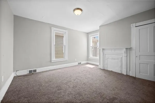 an empty room with windows and closet