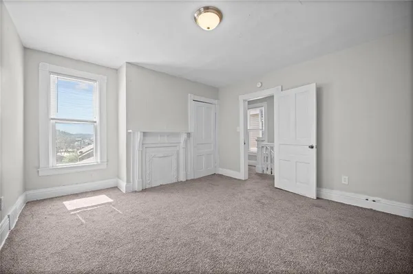 an empty room with windows and closet