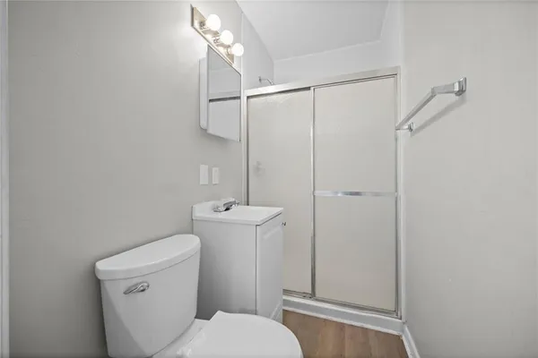 a white toilet sitting next to a shower