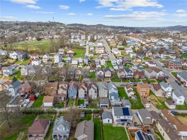 an aerial view of residential houses with outdoor space