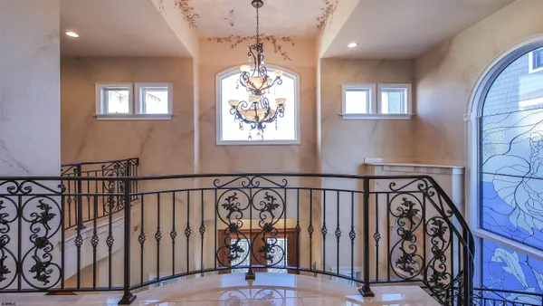 a bedroom with bed and a chandelier
