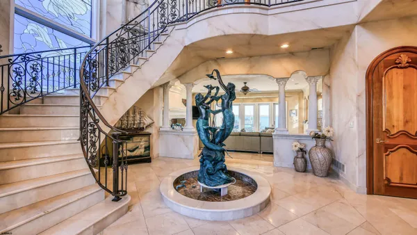 a kitchen with stainless steel appliances granite countertop a sink a stove and a refrigerator