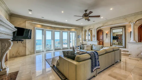 a dining room with furniture a chandelier and a rug