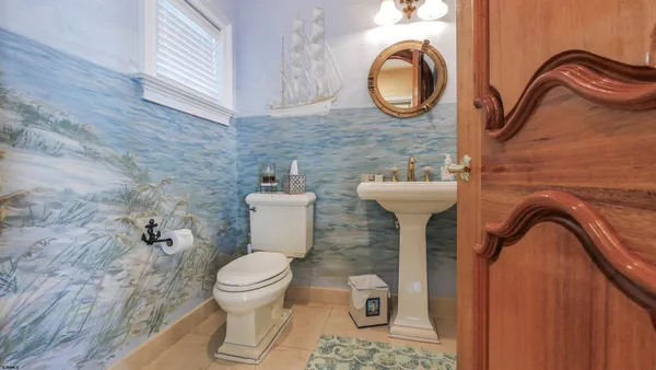 a bathroom with a granite countertop sink a mirror and shower