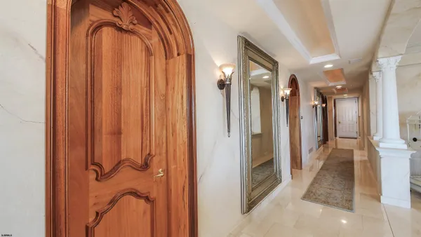 a spacious bedroom with a bed and ceiling fan