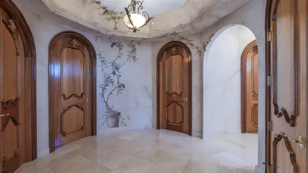 a bedroom with a large bed and a chandelier