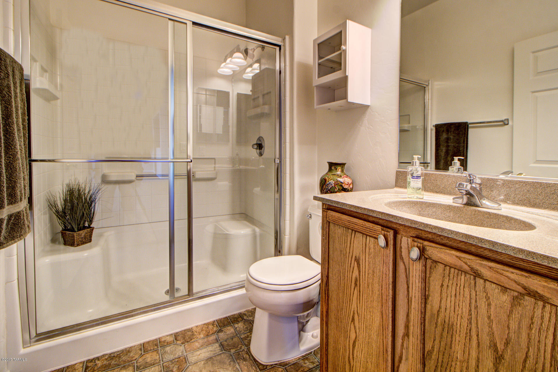 3588 East Mecate Road Tucson, AZ 85739 - Photo 15 of 36 a bathroom with a sink toilet and shower