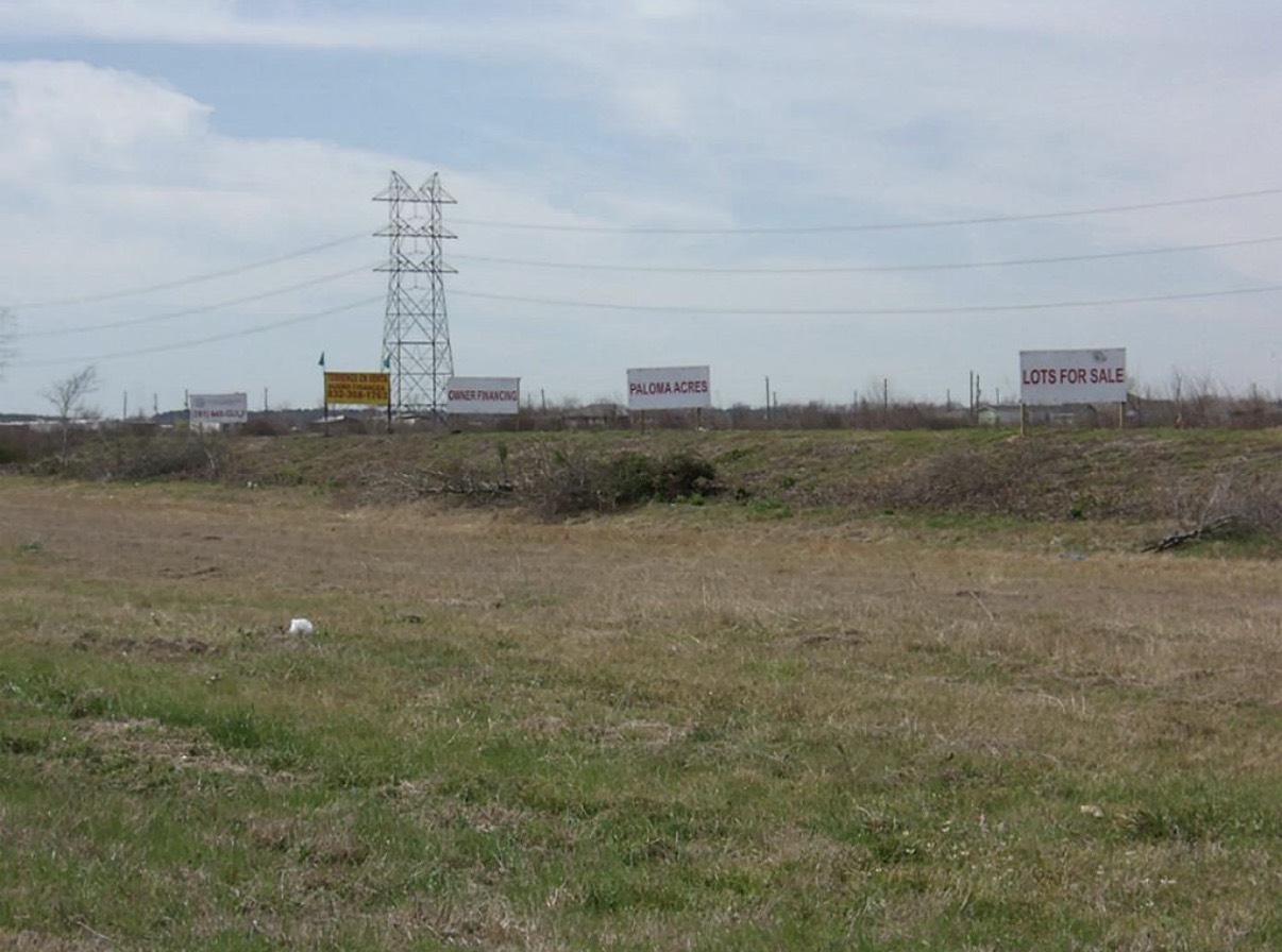 1080 South Paloma Drive Rosharon, TX 77583 - Photo 3 of 4 a view of a lake with a large bridge