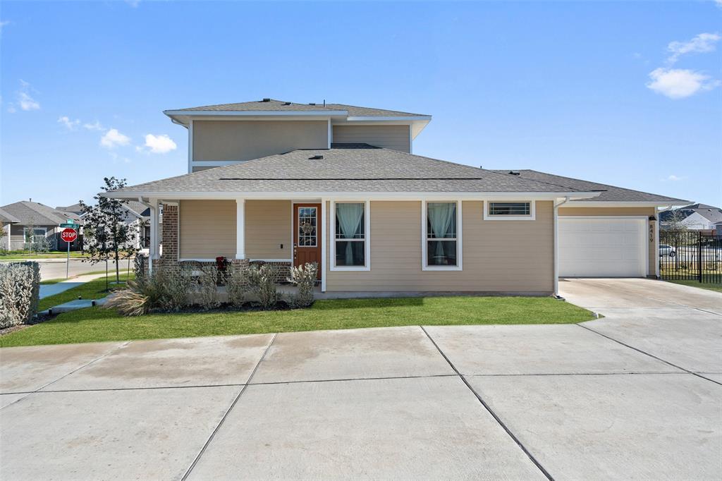 View of front of property with driveway, a shingled roof, and an attached garage
