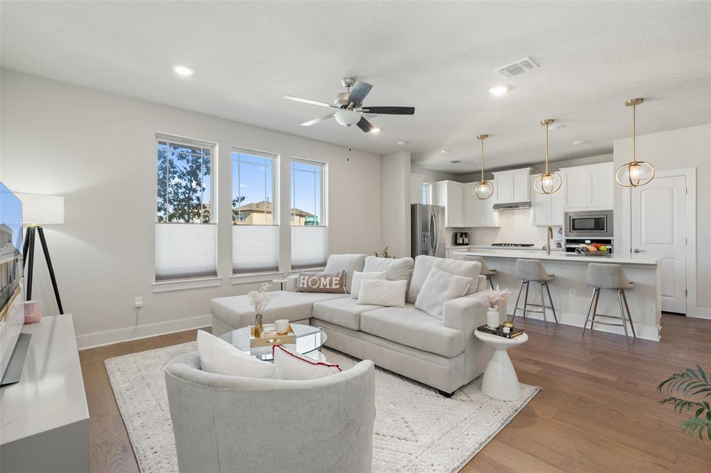 8419 Laughlin Lane Austin, TX 78744 - Photo 10 of 40 Living area featuring light wood-style flooring, ceiling fan, and recessed lighting
